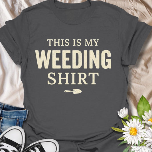 Funny gardening t-shirt featuring the phrase “This Is My Weeding Shirt.” A simple, bold tee for gardeners, plant lovers, and backyard growers who know weeding is just part of the job and somehow still part of the fun.