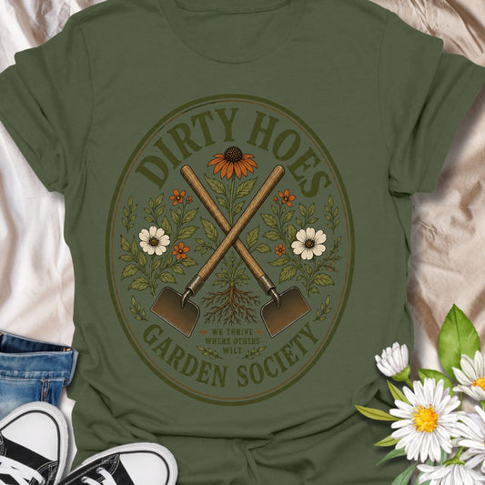 Join the Dirty Hoes Garden Society with this vintage-inspired gardening t-shirt made for plant lovers, backyard growers, and anyone happiest with their hands in the soil. Featuring crossed garden hoes, botanical florals, roots, and a bold retro badge layout, this design brings playful garden humor to a classic outdoorsy look. Perfect for gardeners, homesteaders, flower growers, plant moms, allotment lovers, and anyone who knows the best days start with dirt under their nails.