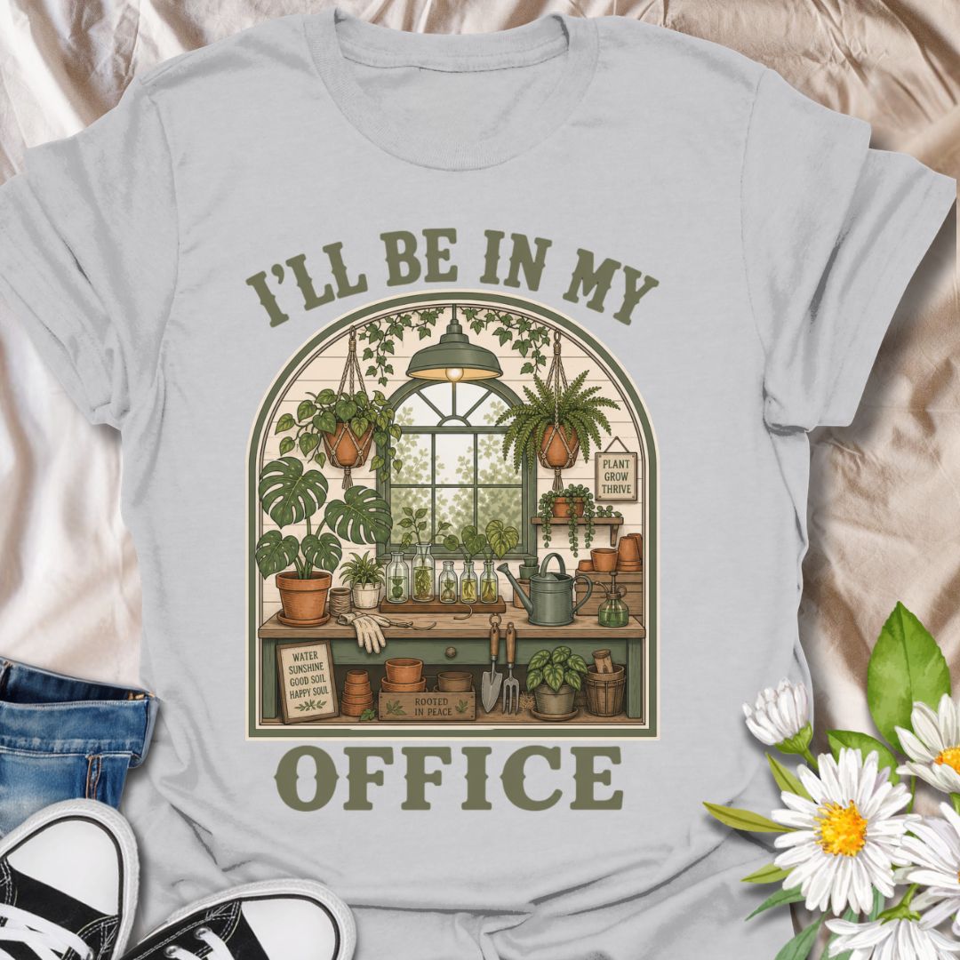 This I’ll Be In My Office t-shirt is made for plant lovers who would rather be surrounded by houseplants, propagation jars, watering cans, and greenhouse calm. The cozy illustrated design features a charming indoor plant room filled with hanging baskets, leafy plants, garden tools, and botanical details for a peaceful plant-parent feel. Perfect for plant moms, houseplant collectors, gardeners, greenhouse lovers, propagation fans, and anyone whose happy place is their own leafy little office.
