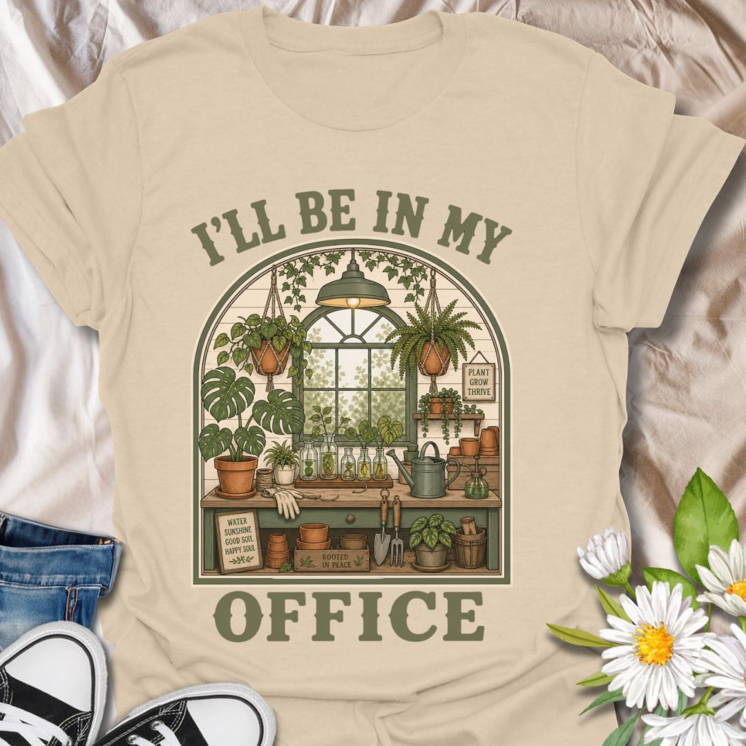 This I’ll Be In My Office t-shirt is made for plant lovers who would rather be surrounded by houseplants, propagation jars, watering cans, and greenhouse calm. The cozy illustrated design features a charming indoor plant room filled with hanging baskets, leafy plants, garden tools, and botanical details for a peaceful plant-parent feel. Perfect for plant moms, houseplant collectors, gardeners, greenhouse lovers, propagation fans, and anyone whose happy place is their own leafy little office.