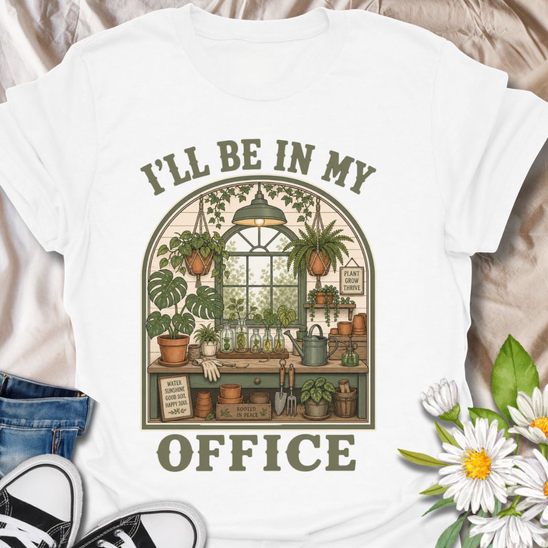 This I’ll Be In My Office t-shirt is made for plant lovers who would rather be surrounded by houseplants, propagation jars, watering cans, and greenhouse calm. The cozy illustrated design features a charming indoor plant room filled with hanging baskets, leafy plants, garden tools, and botanical details for a peaceful plant-parent feel. Perfect for plant moms, houseplant collectors, gardeners, greenhouse lovers, propagation fans, and anyone whose happy place is their own leafy little office.