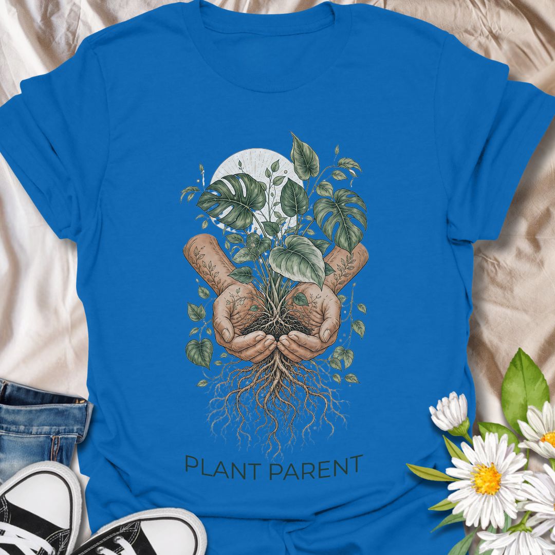 This Plant Parent t-shirt is made for houseplant lovers who know that caring for leaves, roots, and new growth feels a little like raising a tiny indoor jungle. The detailed botanical design features cupped hands holding a thriving plant with visible roots, leafy vines, and soft natural linework for an earthy, artistic plant-lover look. Perfect for plant moms, plant dads, houseplant collectors, propagation fans, gardeners, and anyone who takes their role as a plant parent seriously.