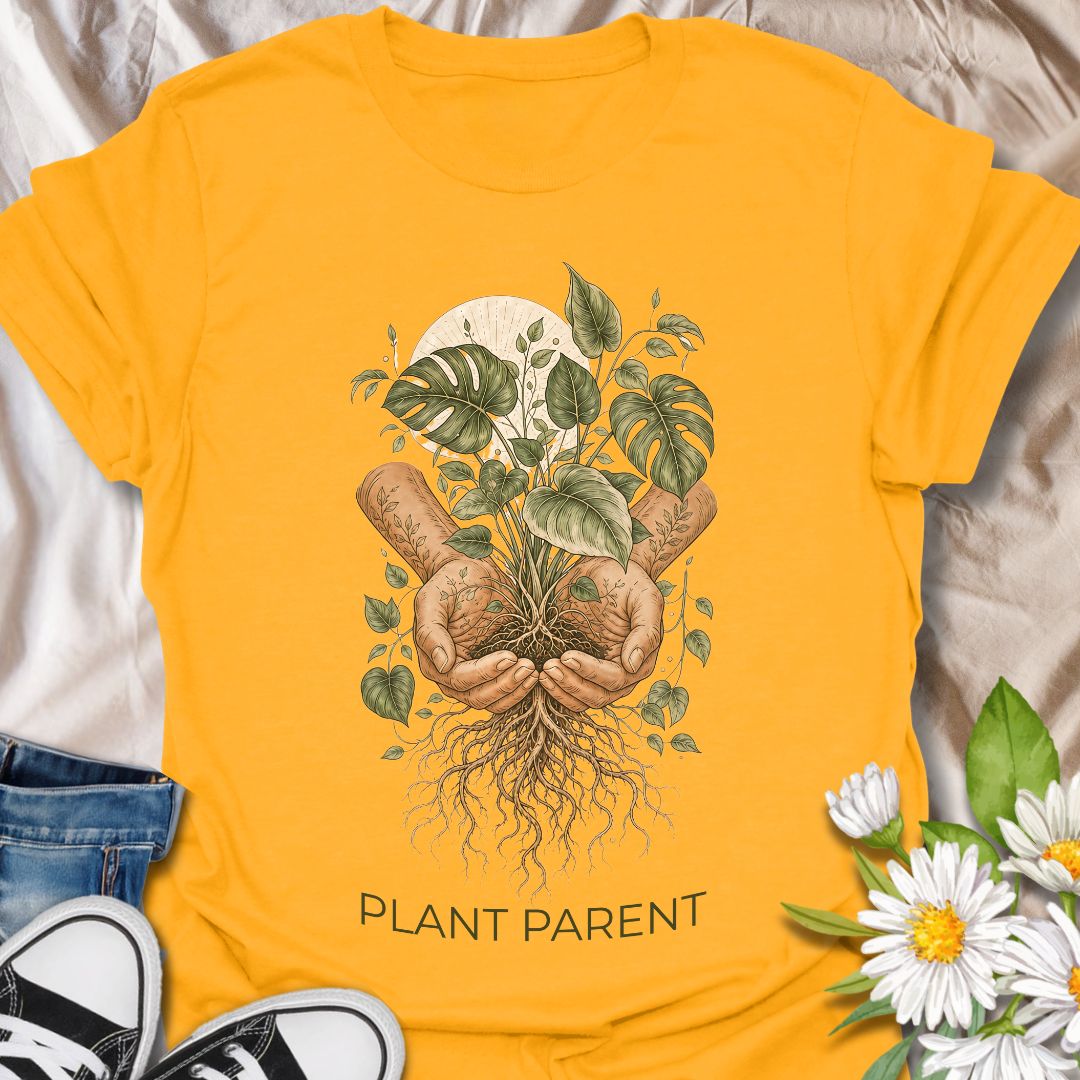 This Plant Parent t-shirt is made for houseplant lovers who know that caring for leaves, roots, and new growth feels a little like raising a tiny indoor jungle. The detailed botanical design features cupped hands holding a thriving plant with visible roots, leafy vines, and soft natural linework for an earthy, artistic plant-lover look. Perfect for plant moms, plant dads, houseplant collectors, propagation fans, gardeners, and anyone who takes their role as a plant parent seriously.
