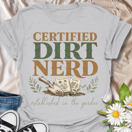 This Certified Dirt Nerd t-shirt is made for gardeners who love soil, seeds, herbs, wildflowers, and getting their hands dirty. Featuring bold vintage typography, a garden trowel, seed packets, leafy details, and the phrase established in the garden, this design has a playful retro look for proud plant and garden lovers. Perfect for backyard gardeners, allotment growers, plant parents, homesteaders, flower growers, herb gardeners, and anyone who happily identifies as a dirt nerd.