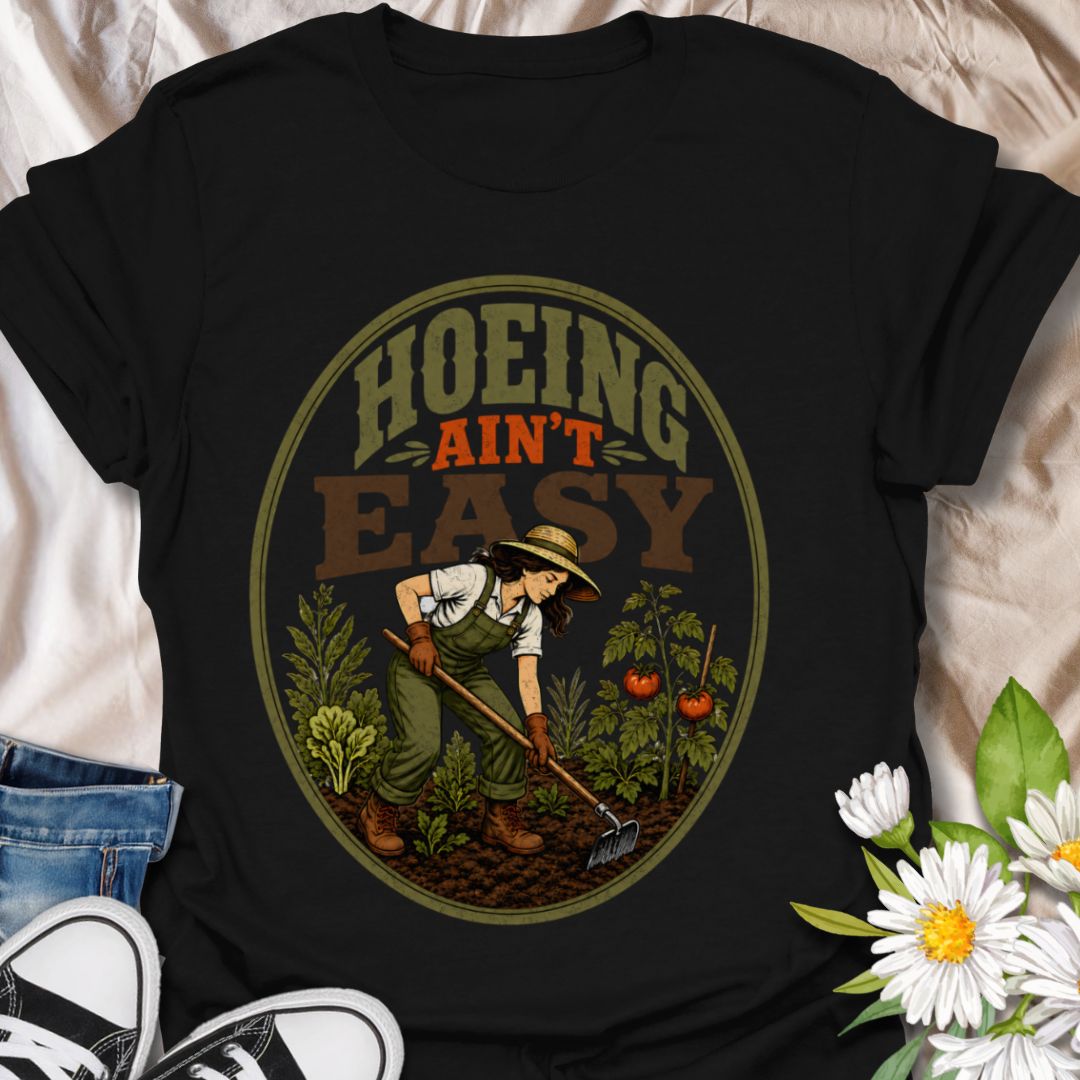 This Hoeing Ain’t Easy t-shirt is made for gardeners who know that growing tomatoes, tending soil, and keeping the garden alive takes real work. The vintage-inspired design features a gardener using a hoe among vegetables, leafy plants, tomatoes, and rich garden soil, giving it a funny but classic homestead garden feel. Perfect for backyard gardeners, vegetable growers, allotment keepers, homesteaders, tomato gardeners, plant lovers, and anyone who knows garden chores are worth it.