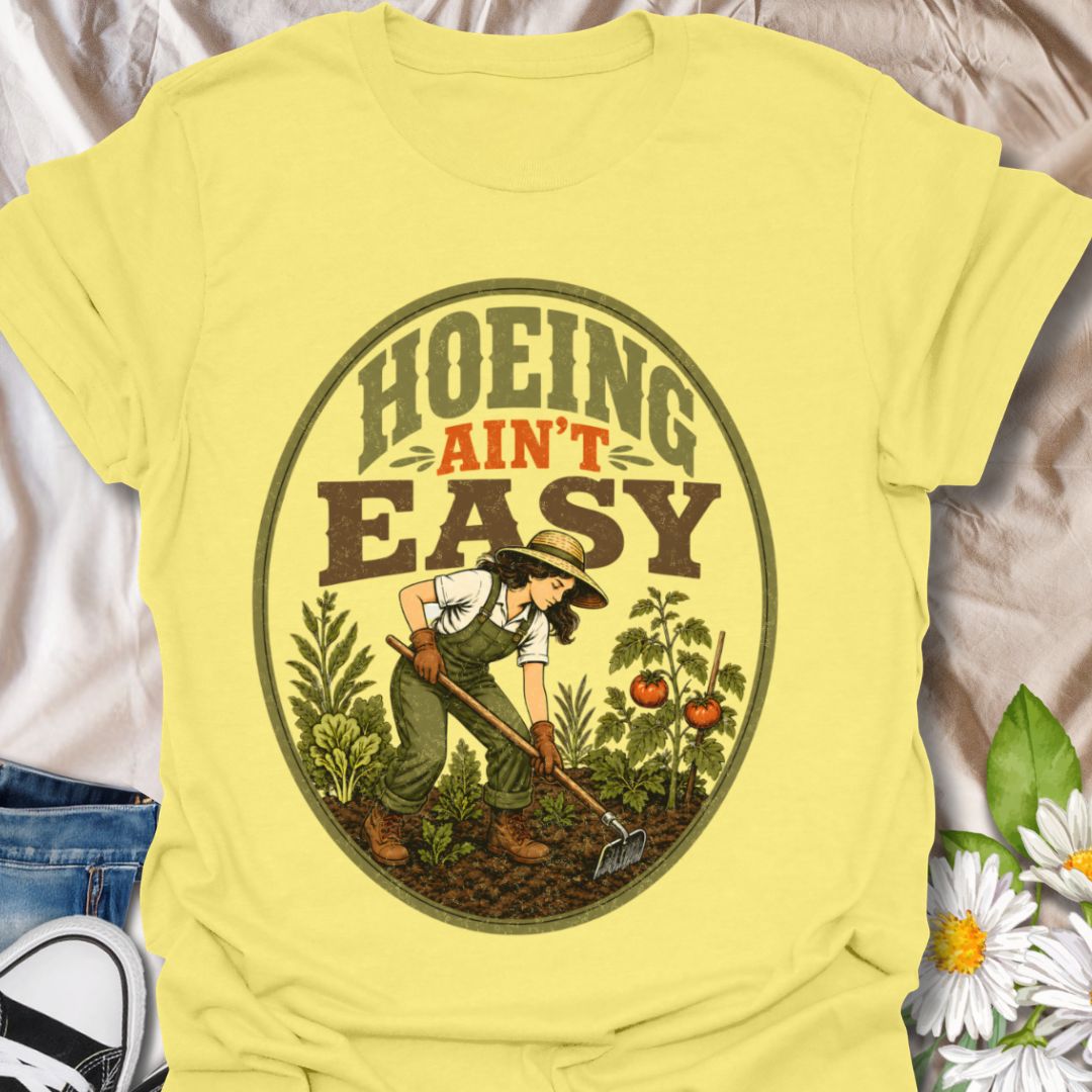 This Hoeing Ain’t Easy t-shirt is made for gardeners who know that growing tomatoes, tending soil, and keeping the garden alive takes real work. The vintage-inspired design features a gardener using a hoe among vegetables, leafy plants, tomatoes, and rich garden soil, giving it a funny but classic homestead garden feel. Perfect for backyard gardeners, vegetable growers, allotment keepers, homesteaders, tomato gardeners, plant lovers, and anyone who knows garden chores are worth it.