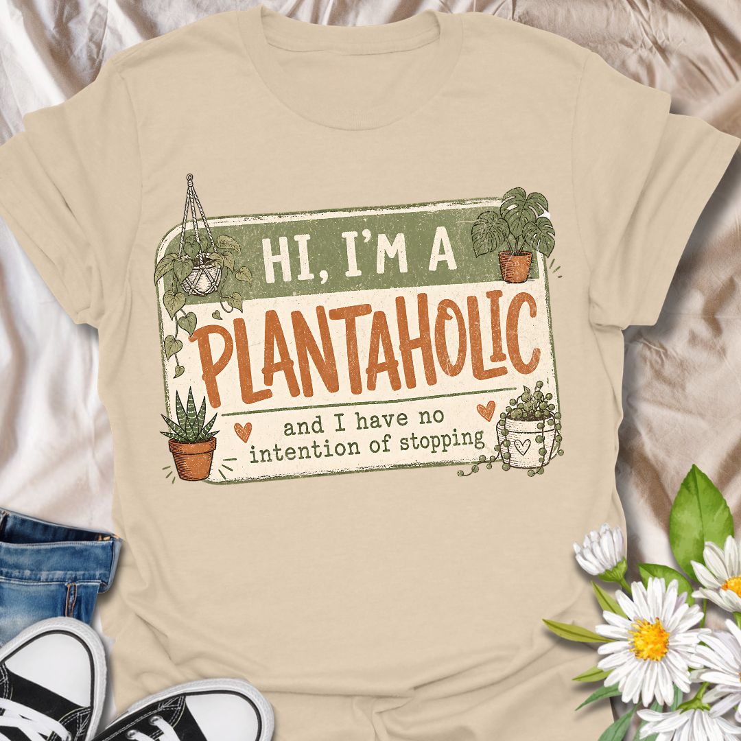 This Hi, I’m A Plantaholic t-shirt is perfect for plant lovers who can never resist one more houseplant. Featuring a playful badge-style layout with potted plants, trailing vines, and the phrase and I have no intention of stopping, this design brings a fun and relatable plant-parent vibe to any casual outfit. A great gift for plant moms, houseplant collectors, propagation fans, indoor gardeners, and anyone proudly obsessed with their growing plant collection.