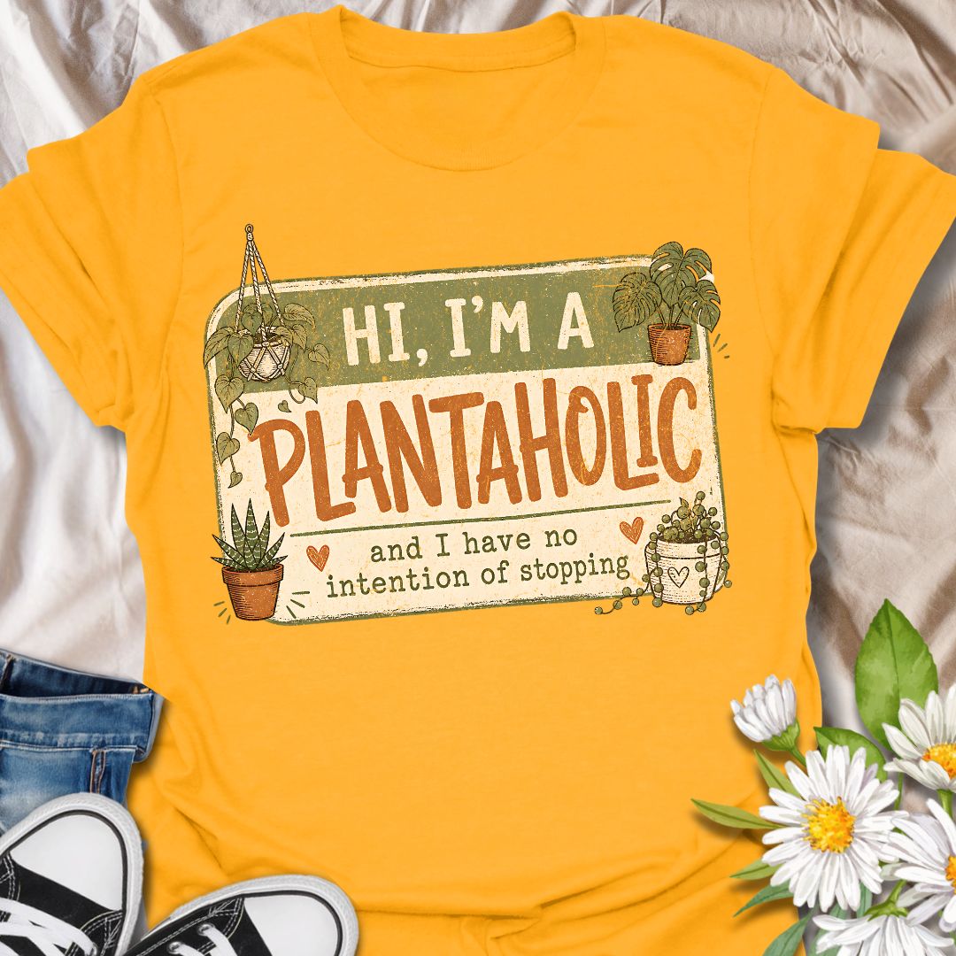 This Hi, I’m A Plantaholic t-shirt is perfect for plant lovers who can never resist one more houseplant. Featuring a playful badge-style layout with potted plants, trailing vines, and the phrase and I have no intention of stopping, this design brings a fun and relatable plant-parent vibe to any casual outfit. A great gift for plant moms, houseplant collectors, propagation fans, indoor gardeners, and anyone proudly obsessed with their growing plant collection.