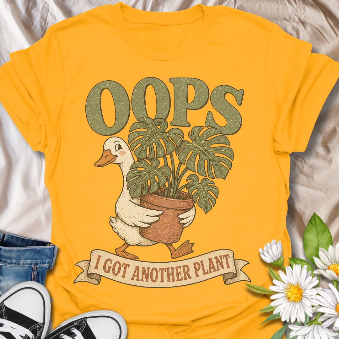 This Oops I Got Another Plant t-shirt is made for houseplant lovers who know exactly how one quick look at a plant shop turns into a new leafy addition. Featuring a cute goose carrying a potted monstera, bold retro lettering, and a playful banner design, this tee is funny, charming, and perfect for proud plant collectors. A great gift for plant moms, plant dads, indoor gardeners, propagation fans, monstera lovers, and anyone who always has room for just one more plant.