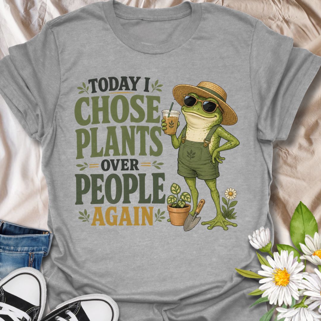 This Today I Chose Plants Over People Again t-shirt is made for plant lovers who would rather spend the day with leaves, soil, iced coffee, and zero unnecessary social plans. Featuring a smug garden frog in sunglasses, a straw hat, overalls, bold vintage lettering, and playful plant details, this design has a funny, snarky botanical vibe. Perfect for plant moms, houseplant lovers, gardeners, introverts, frog fans, and anyone who happily chooses plants over people.