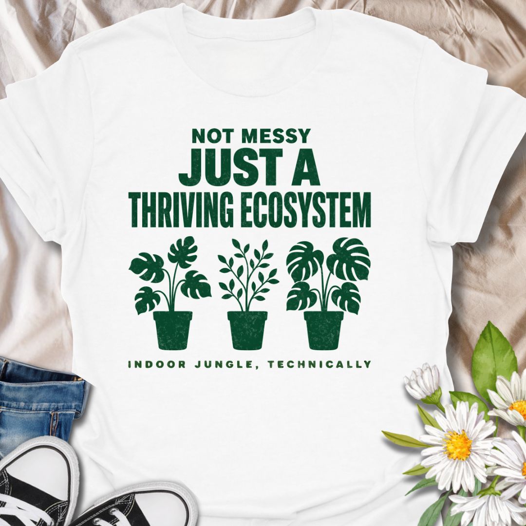 This Not Messy Just A Thriving Ecosystem t-shirt is made for houseplant lovers whose indoor jungle has officially taken over the room. Featuring bold green typography, potted plant silhouettes, monstera leaves, and the phrase indoor jungle, technically, this design is funny, relatable, and perfect for proud plant collectors. A great gift for plant moms, plant dads, houseplant lovers, indoor gardeners, and anyone who knows a few extra plants absolutely counts as an ecosystem.