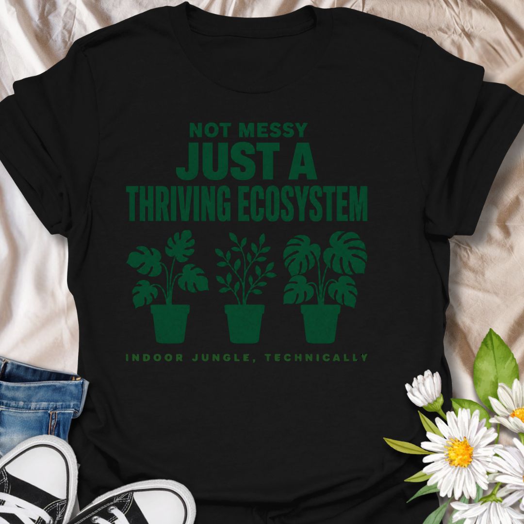 This Not Messy Just A Thriving Ecosystem t-shirt is made for houseplant lovers whose indoor jungle has officially taken over the room. Featuring bold green typography, potted plant silhouettes, monstera leaves, and the phrase indoor jungle, technically, this design is funny, relatable, and perfect for proud plant collectors. A great gift for plant moms, plant dads, houseplant lovers, indoor gardeners, and anyone who knows a few extra plants absolutely counts as an ecosystem.
