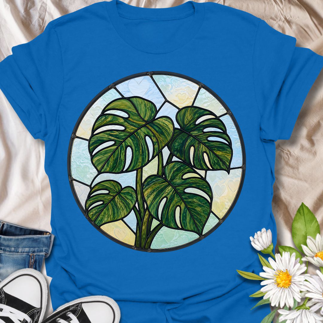 This Stained Glass Monstera t-shirt is made for houseplant lovers who want a bold, artistic take on their favorite leafy plant. Featuring a circular stained-glass style monstera design with rich green leaves, dark lead-line details, and soft pastel glass panels, this tee has a beautiful botanical look that feels unique and eye-catching. Perfect for plant moms, plant dads, monstera lovers, houseplant collectors, indoor gardeners, and anyone who loves statement plant artwork.