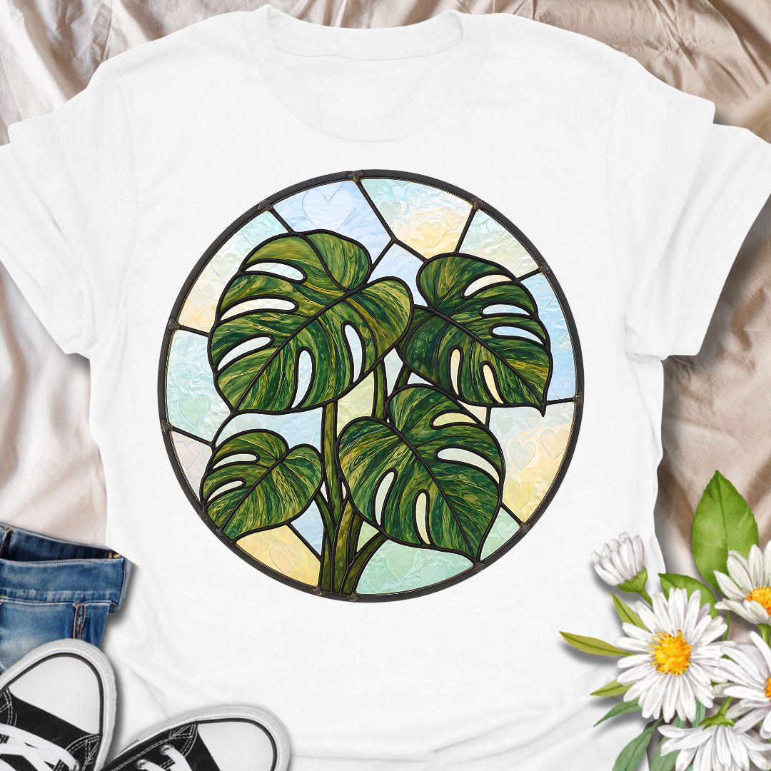 This Stained Glass Monstera t-shirt is made for houseplant lovers who want a bold, artistic take on their favorite leafy plant. Featuring a circular stained-glass style monstera design with rich green leaves, dark lead-line details, and soft pastel glass panels, this tee has a beautiful botanical look that feels unique and eye-catching. Perfect for plant moms, plant dads, monstera lovers, houseplant collectors, indoor gardeners, and anyone who loves statement plant artwork.