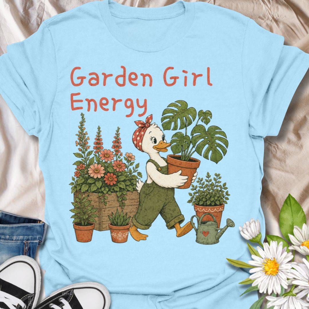 This Garden Girl Energy t-shirt is perfect for plant lovers, flower fans, and gardeners who feel most at home surrounded by blooms and houseplants. Featuring a charming duck gardener in overalls and a polka dot bandana carrying a potted monstera, alongside flowers, pots, and a watering can, this design has a whimsical botanical feel that suits cottagecore style, garden lovers, and anyone proud of their plant-filled lifestyle.
