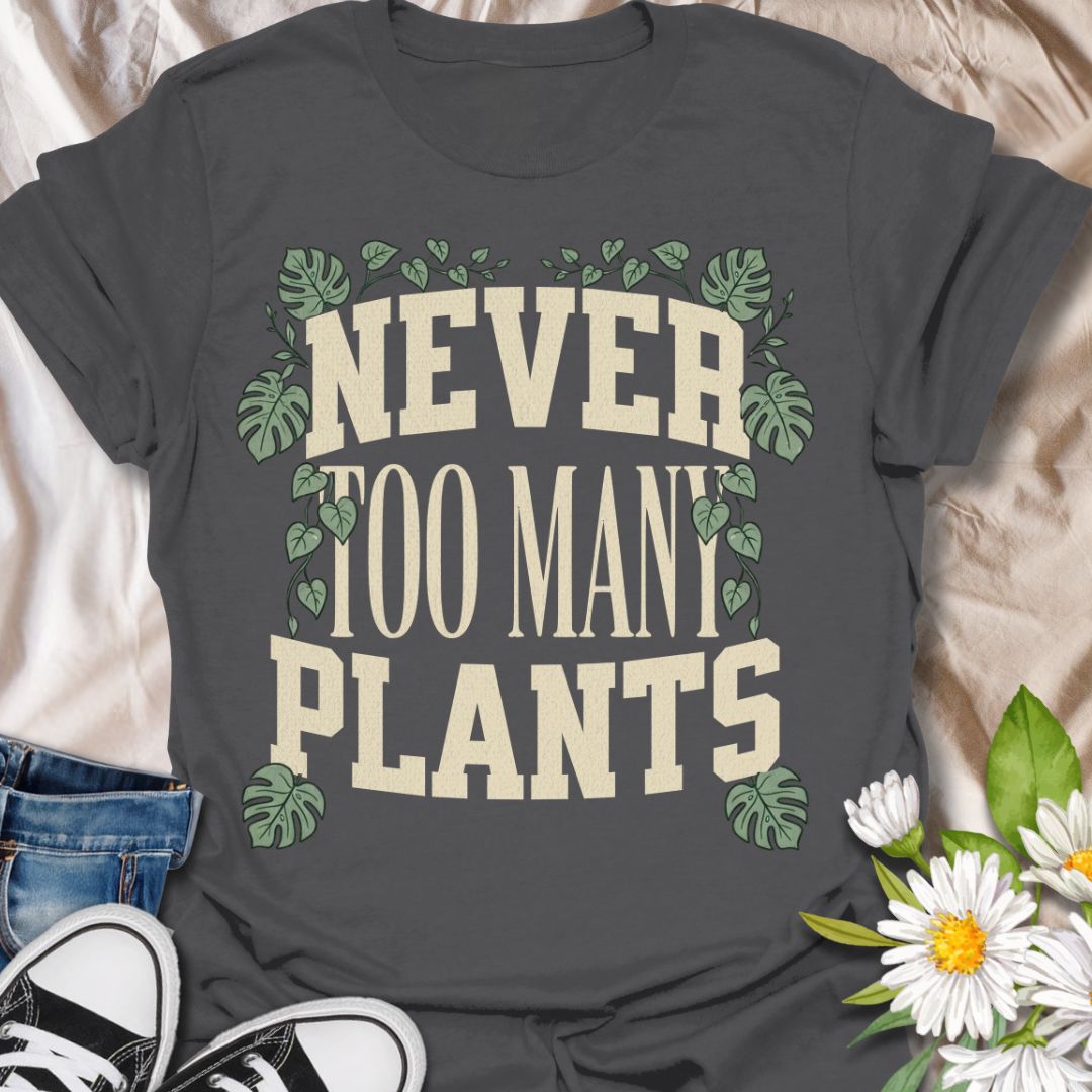 This Never Too Many Plants t-shirt is made for houseplant lovers who know there is always room for one more leafy friend. Featuring bold varsity-style lettering framed with monstera leaves and trailing vines, this design has a clean, statement botanical look for everyday plant-parent wear. Perfect for plant moms, plant dads, indoor gardeners, houseplant collectors, propagation fans, and anyone whose plant collection is never really finished.