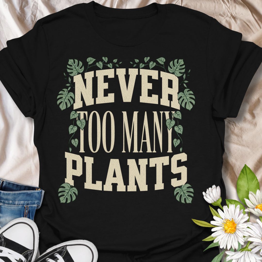 This Never Too Many Plants t-shirt is made for houseplant lovers who know there is always room for one more leafy friend. Featuring bold varsity-style lettering framed with monstera leaves and trailing vines, this design has a clean, statement botanical look for everyday plant-parent wear. Perfect for plant moms, plant dads, indoor gardeners, houseplant collectors, propagation fans, and anyone whose plant collection is never really finished.