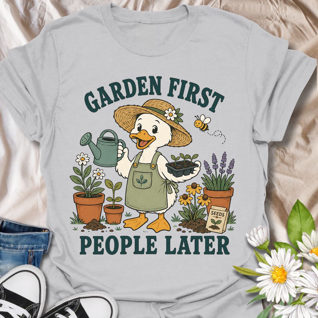 This Garden First People Later t-shirt is made for gardeners who would rather spend the day with seedlings, flowers, soil, and a watering can than deal with unnecessary social plans. Featuring a cheerful duck gardener in a straw hat holding seedlings, surrounded by potted plants, lavender, daisies, a bee, seed packet, and garden details, this design has a cute vintage botanical feel. Perfect for gardeners, plant lovers, backyard growers, flower fans, cottagecore style lovers, and anyone who happily chooses 