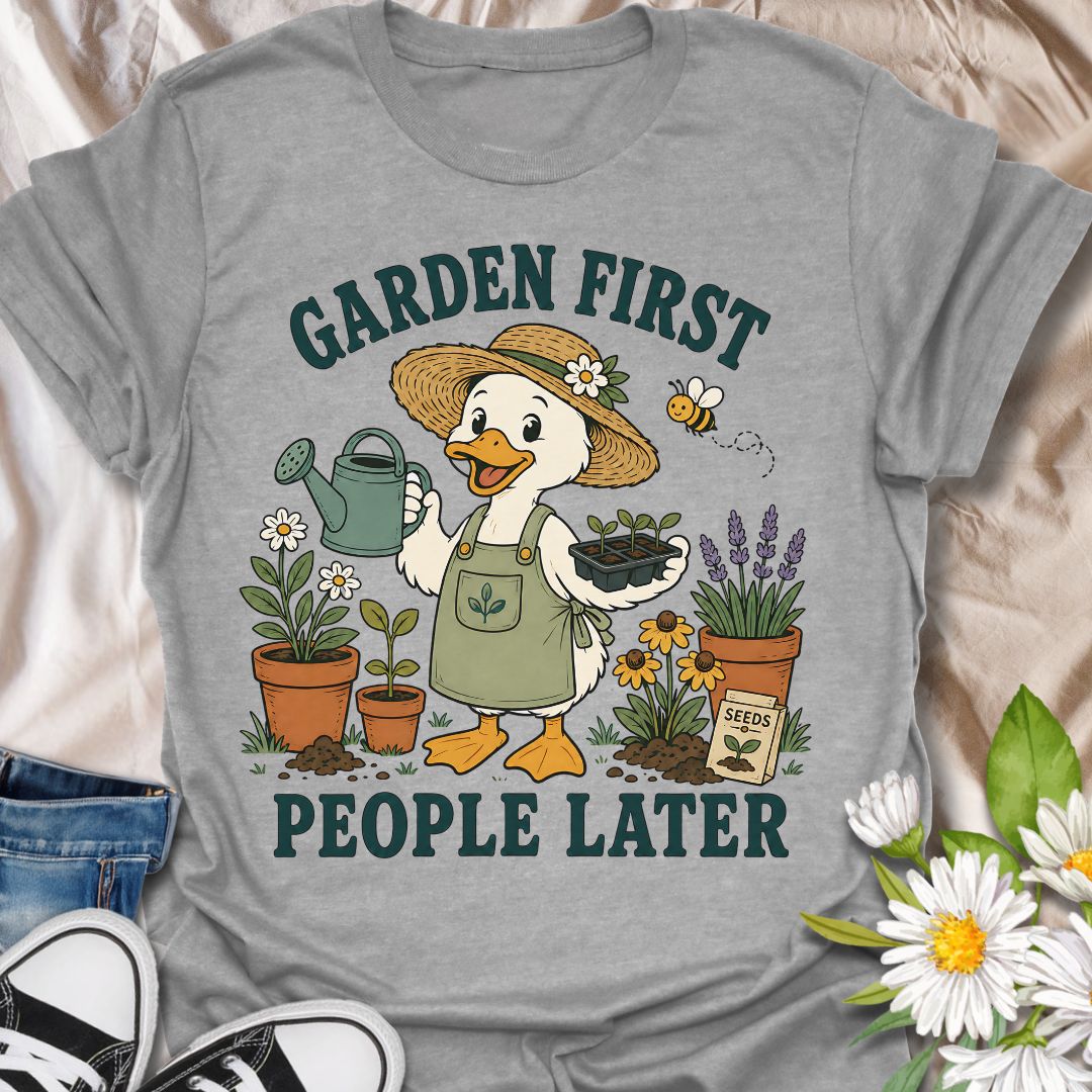 This Garden First People Later t-shirt is made for gardeners who would rather spend the day with seedlings, flowers, soil, and a watering can than deal with unnecessary social plans. Featuring a cheerful duck gardener in a straw hat holding seedlings, surrounded by potted plants, lavender, daisies, a bee, seed packet, and garden details, this design has a cute vintage botanical feel. Perfect for gardeners, plant lovers, backyard growers, flower fans, cottagecore style lovers, and anyone who happily chooses 