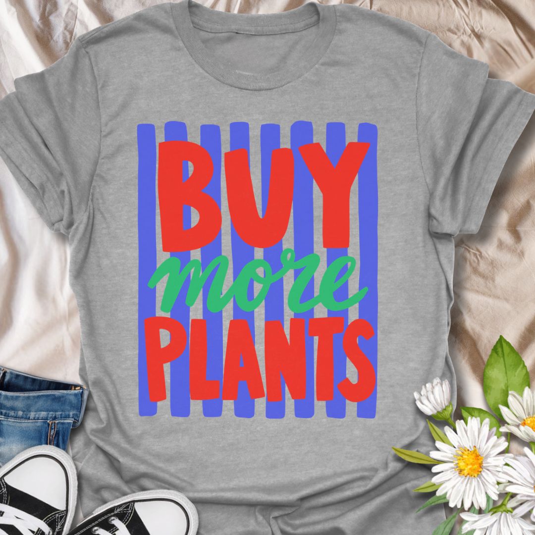 This Buy More Plants t-shirt is made for houseplant lovers who never need convincing to add another leafy friend to the collection. Featuring bold red and green typography over bright blue brushstroke stripes, this design has a fun, modern, colorful look for everyday plant-parent style. Perfect for plant moms, plant dads, indoor gardeners, houseplant collectors, plant shop fans, and anyone who believes the answer is always more plants