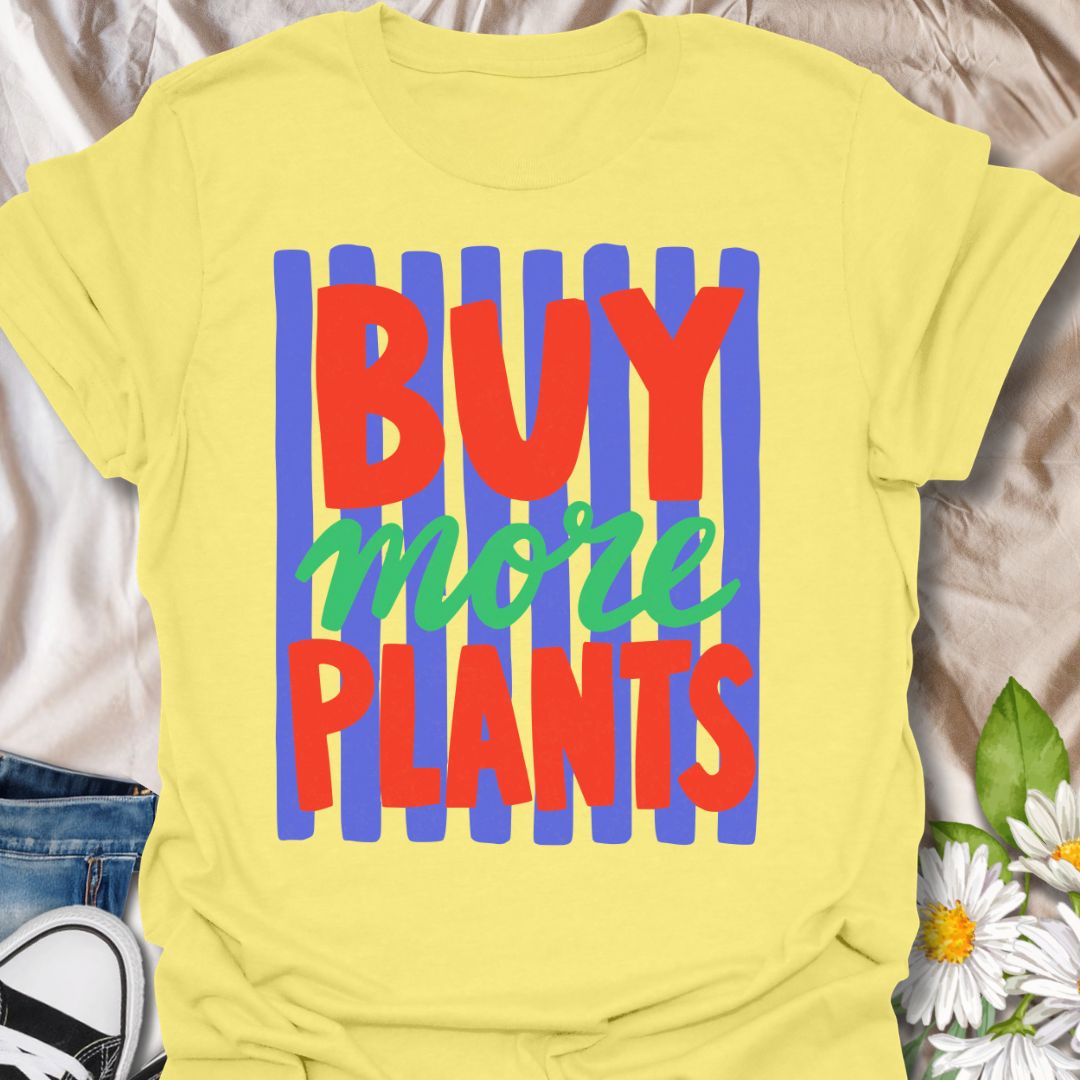 This Buy More Plants t-shirt is made for houseplant lovers who never need convincing to add another leafy friend to the collection. Featuring bold red and green typography over bright blue brushstroke stripes, this design has a fun, modern, colorful look for everyday plant-parent style. Perfect for plant moms, plant dads, indoor gardeners, houseplant collectors, plant shop fans, and anyone who believes the answer is always more plants