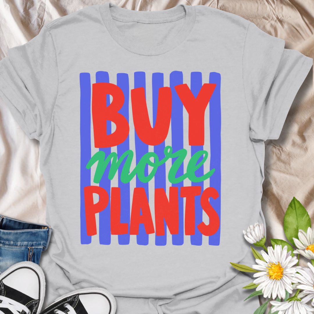 This Buy More Plants t-shirt is made for houseplant lovers who never need convincing to add another leafy friend to the collection. Featuring bold red and green typography over bright blue brushstroke stripes, this design has a fun, modern, colorful look for everyday plant-parent style. Perfect for plant moms, plant dads, indoor gardeners, houseplant collectors, plant shop fans, and anyone who believes the answer is always more plants