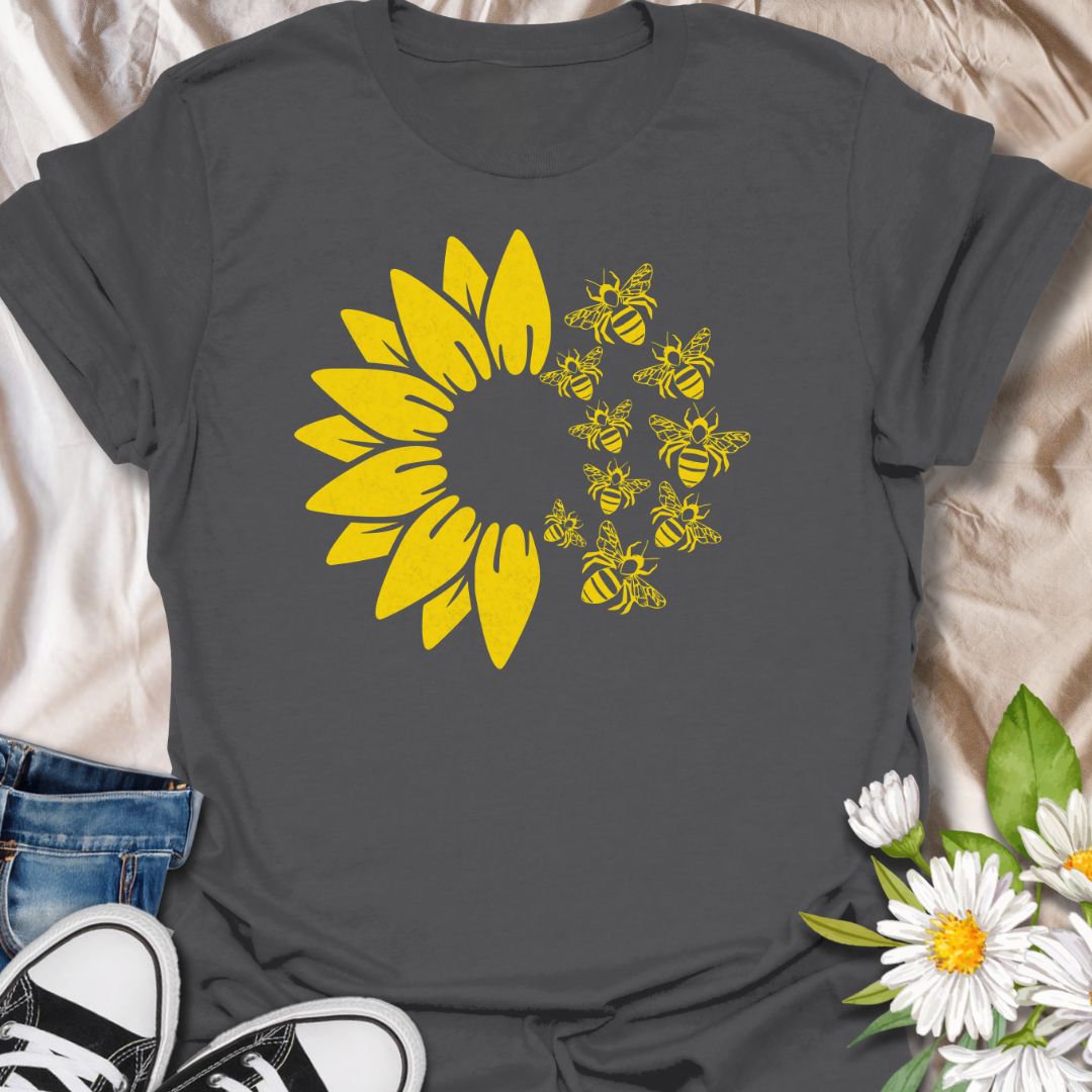 This Sunflower Bees t-shirt is made for nature lovers, gardeners, and pollinator fans who love bright sunny floral designs. Featuring a bold yellow sunflower with a swarm of buzzing bees, this simple single-colour design has a cheerful garden-inspired look that feels clean, fresh, and easy to wear. Perfect for bee lovers, sunflower fans, gardeners, wildflower lovers, pollinator supporters, and anyone who wants a happy nature-themed graphic tee.