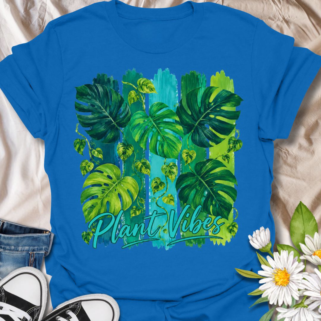 This Plant Vibes t-shirt is made for houseplant lovers who like their botanical style bright, bold, and full of leafy energy. Featuring painterly green monstera leaves, trailing pothos vines, colorful brushstroke stripes, and flowing Plant Vibes lettering, this design has a fresh tropical look for everyday plant-parent wear. Perfect for plant moms, plant dads, indoor gardeners, monstera lovers, houseplant collectors, and anyone who loves a vibrant indoor jungle aesthetic.