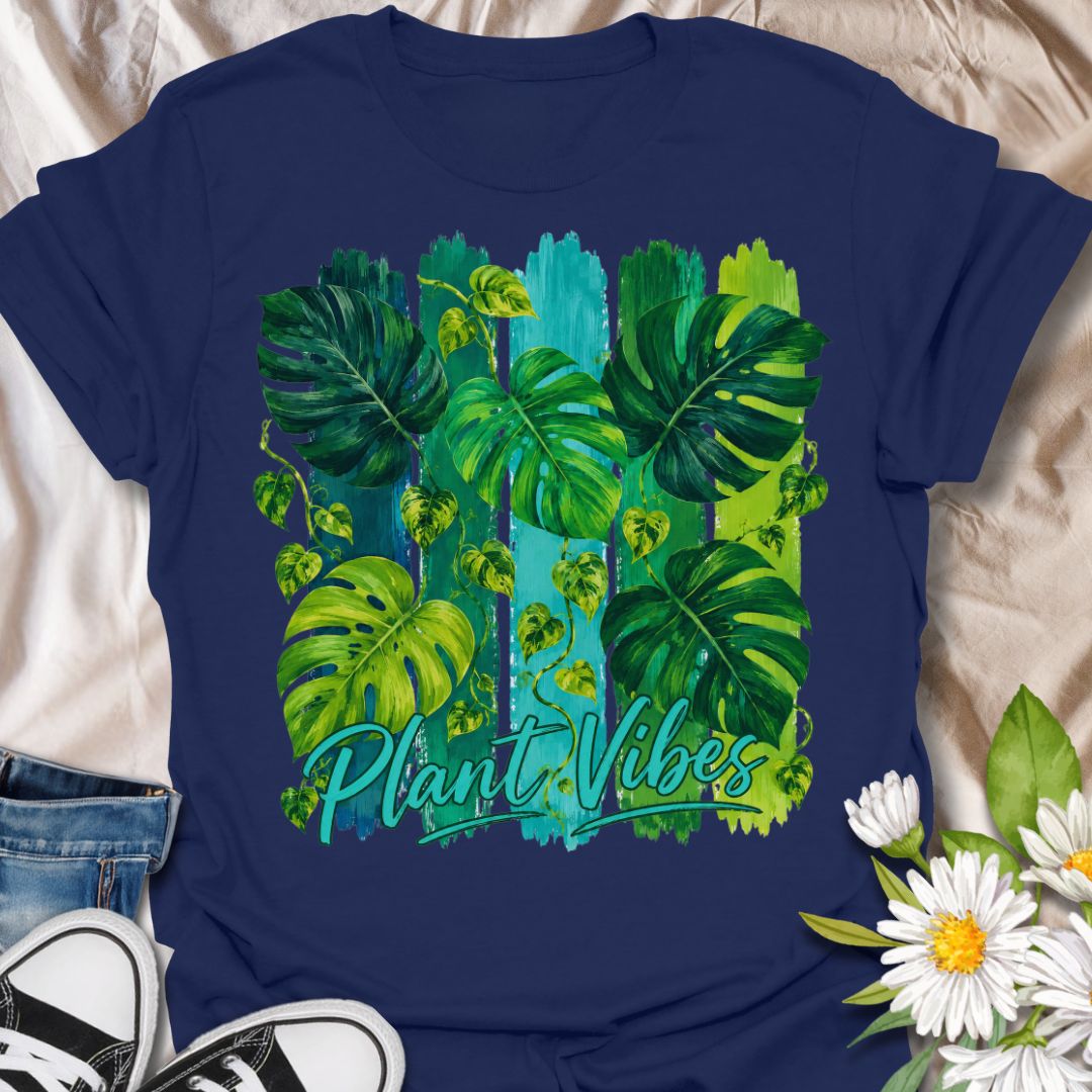 This Plant Vibes t-shirt is made for houseplant lovers who like their botanical style bright, bold, and full of leafy energy. Featuring painterly green monstera leaves, trailing pothos vines, colorful brushstroke stripes, and flowing Plant Vibes lettering, this design has a fresh tropical look for everyday plant-parent wear. Perfect for plant moms, plant dads, indoor gardeners, monstera lovers, houseplant collectors, and anyone who loves a vibrant indoor jungle aesthetic.