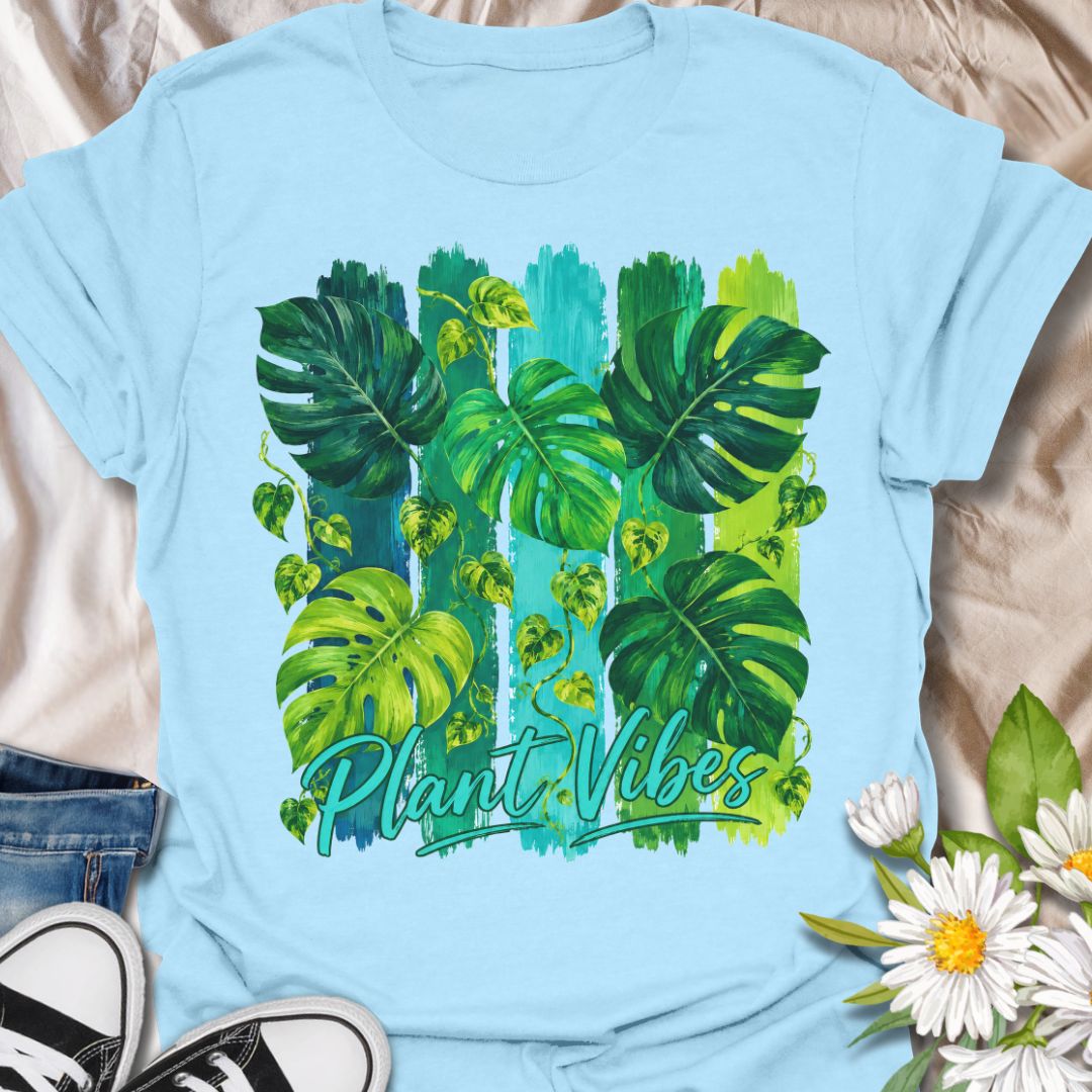 This Plant Vibes t-shirt is made for houseplant lovers who like their botanical style bright, bold, and full of leafy energy. Featuring painterly green monstera leaves, trailing pothos vines, colorful brushstroke stripes, and flowing Plant Vibes lettering, this design has a fresh tropical look for everyday plant-parent wear. Perfect for plant moms, plant dads, indoor gardeners, monstera lovers, houseplant collectors, and anyone who loves a vibrant indoor jungle aesthetic.