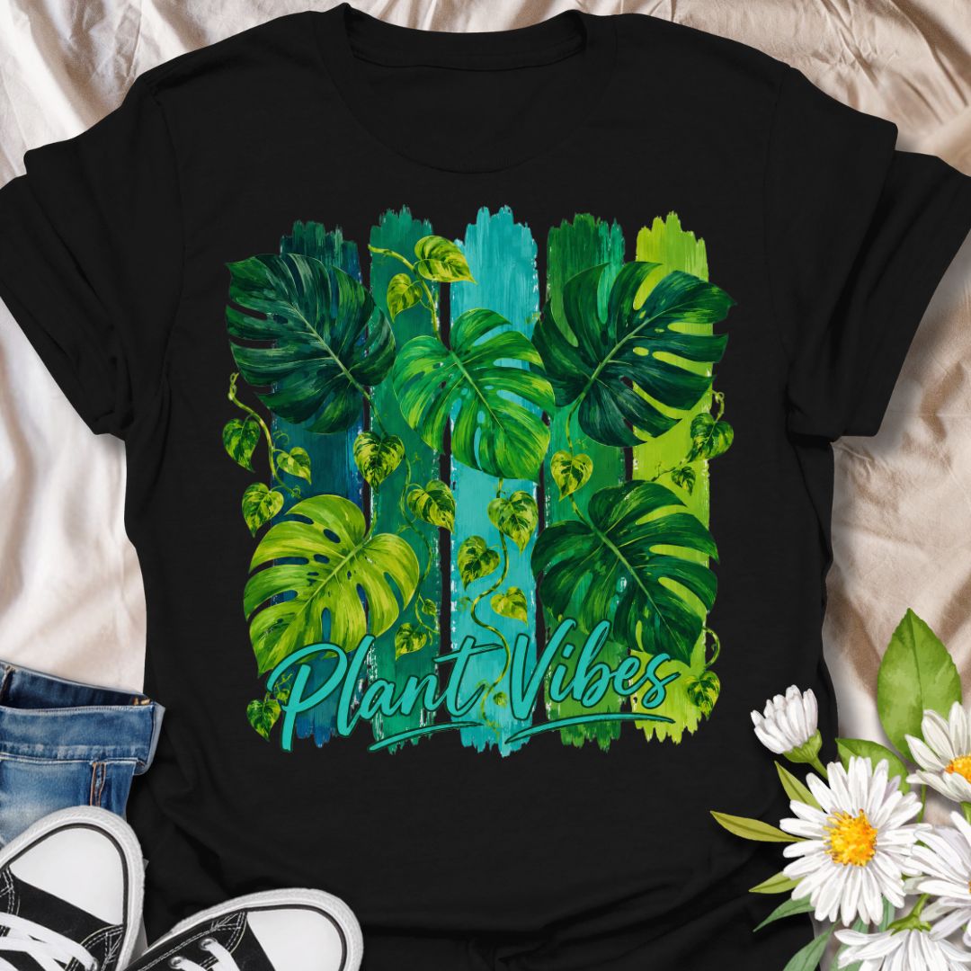 This Plant Vibes t-shirt is made for houseplant lovers who like their botanical style bright, bold, and full of leafy energy. Featuring painterly green monstera leaves, trailing pothos vines, colorful brushstroke stripes, and flowing Plant Vibes lettering, this design has a fresh tropical look for everyday plant-parent wear. Perfect for plant moms, plant dads, indoor gardeners, monstera lovers, houseplant collectors, and anyone who loves a vibrant indoor jungle aesthetic.