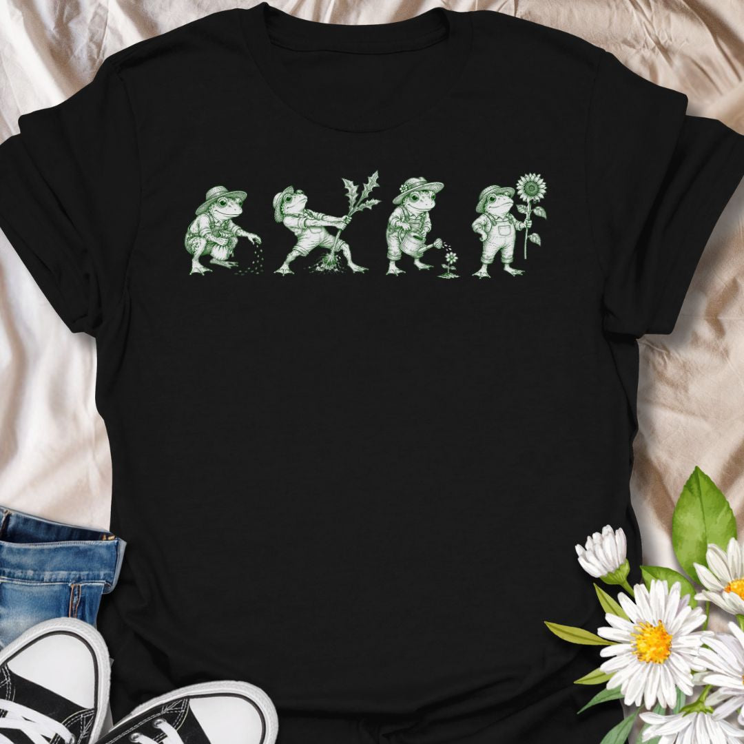 This Gardening Frogs t-shirt is made for plant lovers, gardeners, and frog fans who enjoy a whimsical nature-inspired design. Featuring four charming frogs doing garden tasks in a vintage green ink illustration style, this design has a playful cottagecore feel with plenty of botanical personality. Perfect for gardeners, plant moms, frog lovers, nature fans, cottagecore style lovers, and anyone who thinks gardening is better with a little amphibian charm.