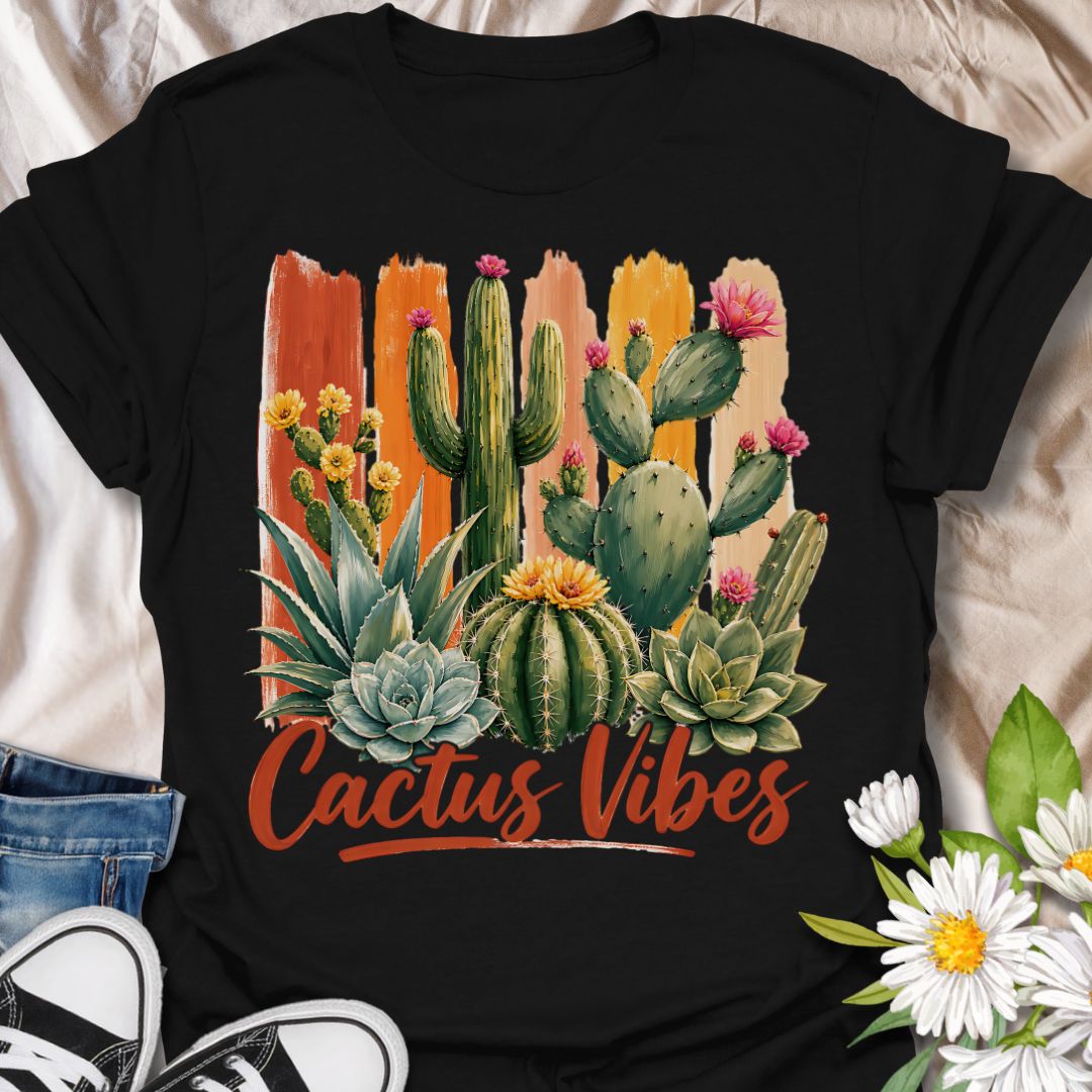This Cactus Vibes t-shirt is made for plant lovers who are drawn to desert plants, succulents, and bold botanical artwork. Featuring a colorful cactus and succulent arrangement with painterly brushstroke accents, blooming prickly pear flowers, agave, and warm earthy lettering, this design has a bright southwestern garden feel. Perfect for cactus lovers, succulent fans, plant moms, plant dads, desert plant collectors, and anyone who loves relaxed plant vibes.