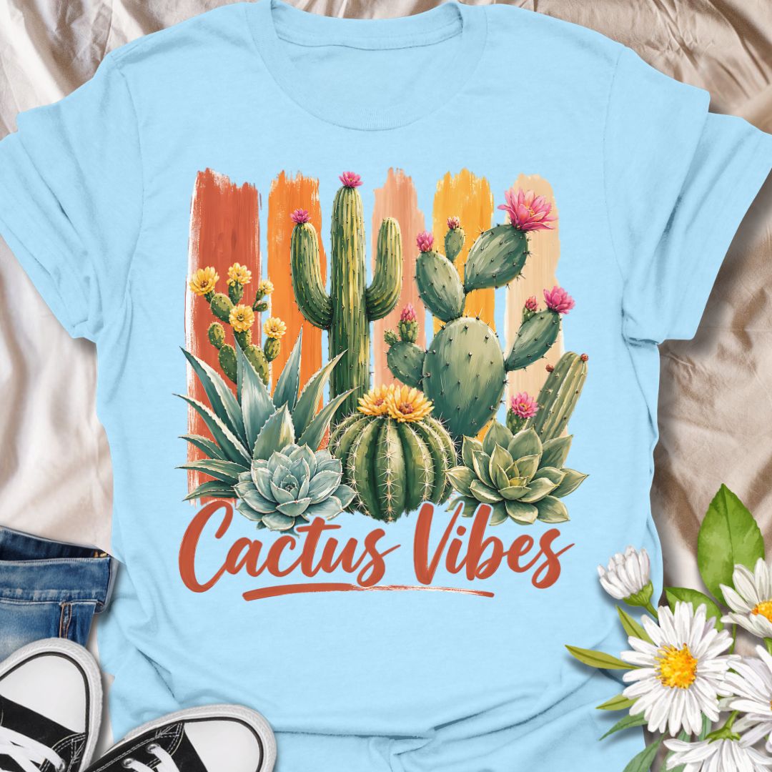 This Cactus Vibes t-shirt is made for plant lovers who are drawn to desert plants, succulents, and bold botanical artwork. Featuring a colorful cactus and succulent arrangement with painterly brushstroke accents, blooming prickly pear flowers, agave, and warm earthy lettering, this design has a bright southwestern garden feel. Perfect for cactus lovers, succulent fans, plant moms, plant dads, desert plant collectors, and anyone who loves relaxed plant vibes.