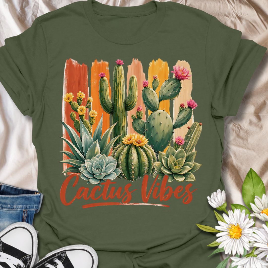 This Cactus Vibes t-shirt is made for plant lovers who are drawn to desert plants, succulents, and bold botanical artwork. Featuring a colorful cactus and succulent arrangement with painterly brushstroke accents, blooming prickly pear flowers, agave, and warm earthy lettering, this design has a bright southwestern garden feel. Perfect for cactus lovers, succulent fans, plant moms, plant dads, desert plant collectors, and anyone who loves relaxed plant vibes.