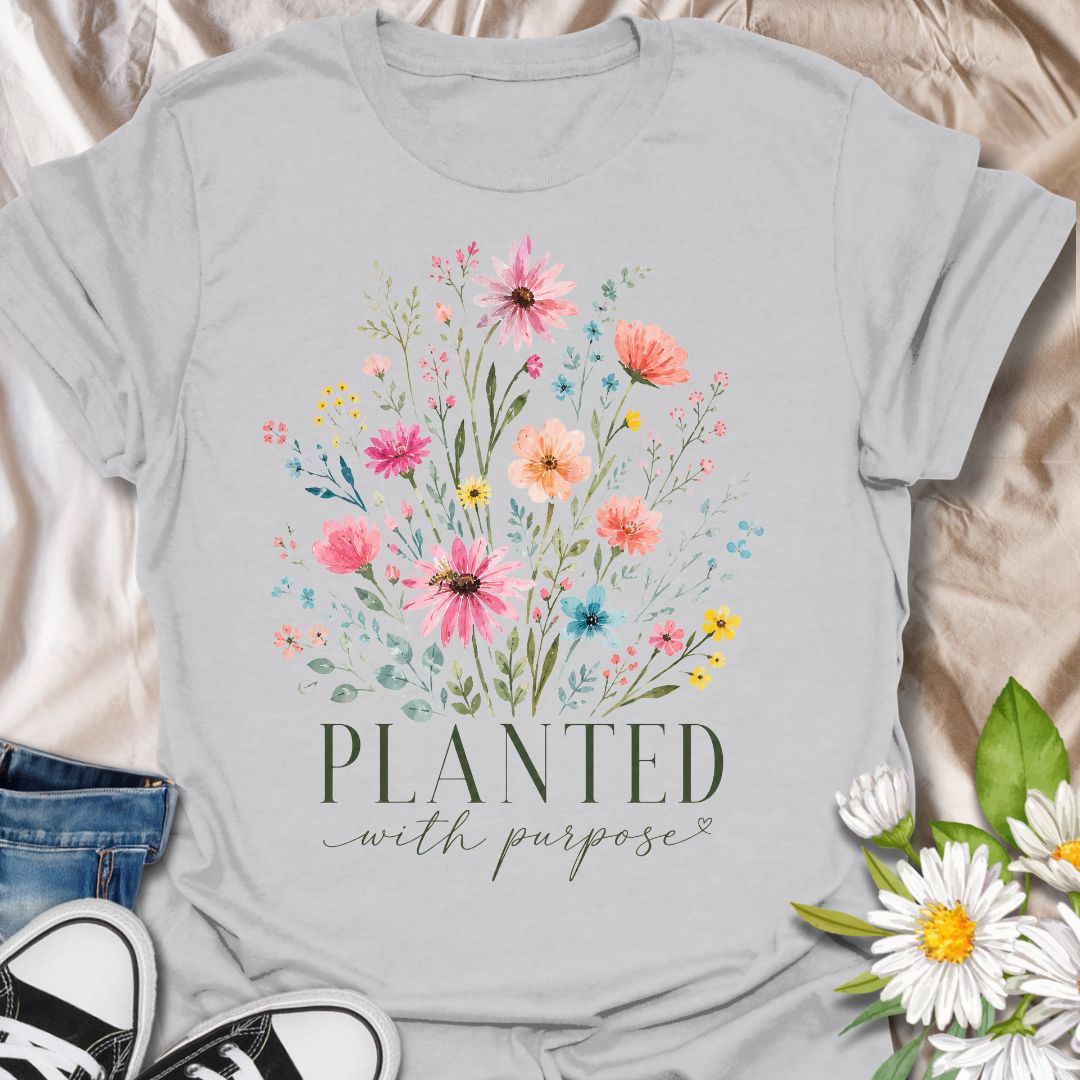 This Planted With Purpose t-shirt is made for flower lovers, gardeners, and anyone drawn to soft botanical designs with an uplifting message. Featuring a loose watercolor-style wildflower bouquet with pink, coral, yellow, blue, and sage green florals, this design has a feminine, graceful garden-inspired feel. Perfect for plant lovers, flower fans, gardeners, nature lovers, and anyone who loves meaningful floral artwork with a calm, pretty style.