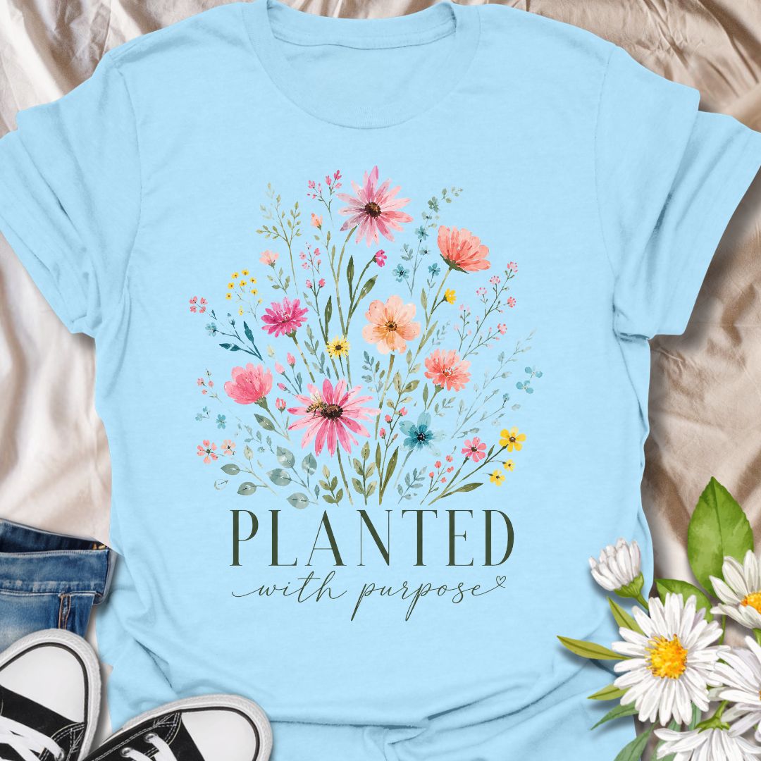 This Planted With Purpose t-shirt is made for flower lovers, gardeners, and anyone drawn to soft botanical designs with an uplifting message. Featuring a loose watercolor-style wildflower bouquet with pink, coral, yellow, blue, and sage green florals, this design has a feminine, graceful garden-inspired feel. Perfect for plant lovers, flower fans, gardeners, nature lovers, and anyone who loves meaningful floral artwork with a calm, pretty style.