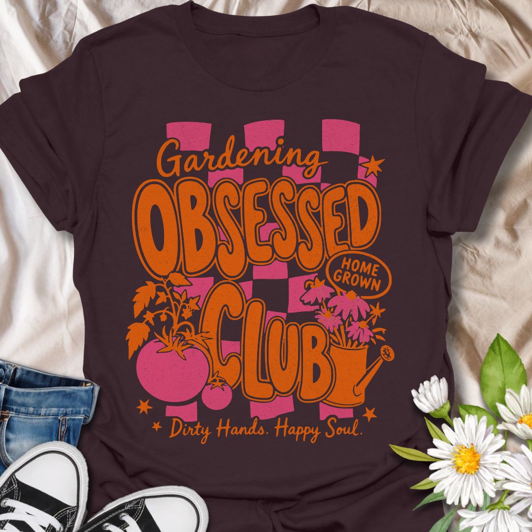 This Gardening Obsessed Club t-shirt is made for gardeners who know dirty hands, homegrown plants, and a happy soul go together perfectly. Featuring bold retro orange lettering, pink checkerboard accents, tomatoes, flowers, a watering can, and playful garden details, this design has a bright vintage-inspired feel full of personality. Perfect for gardeners, plant lovers, vegetable growers, flower fans, cottagecore style lovers, and anyone proudly part of the gardening obsessed club.