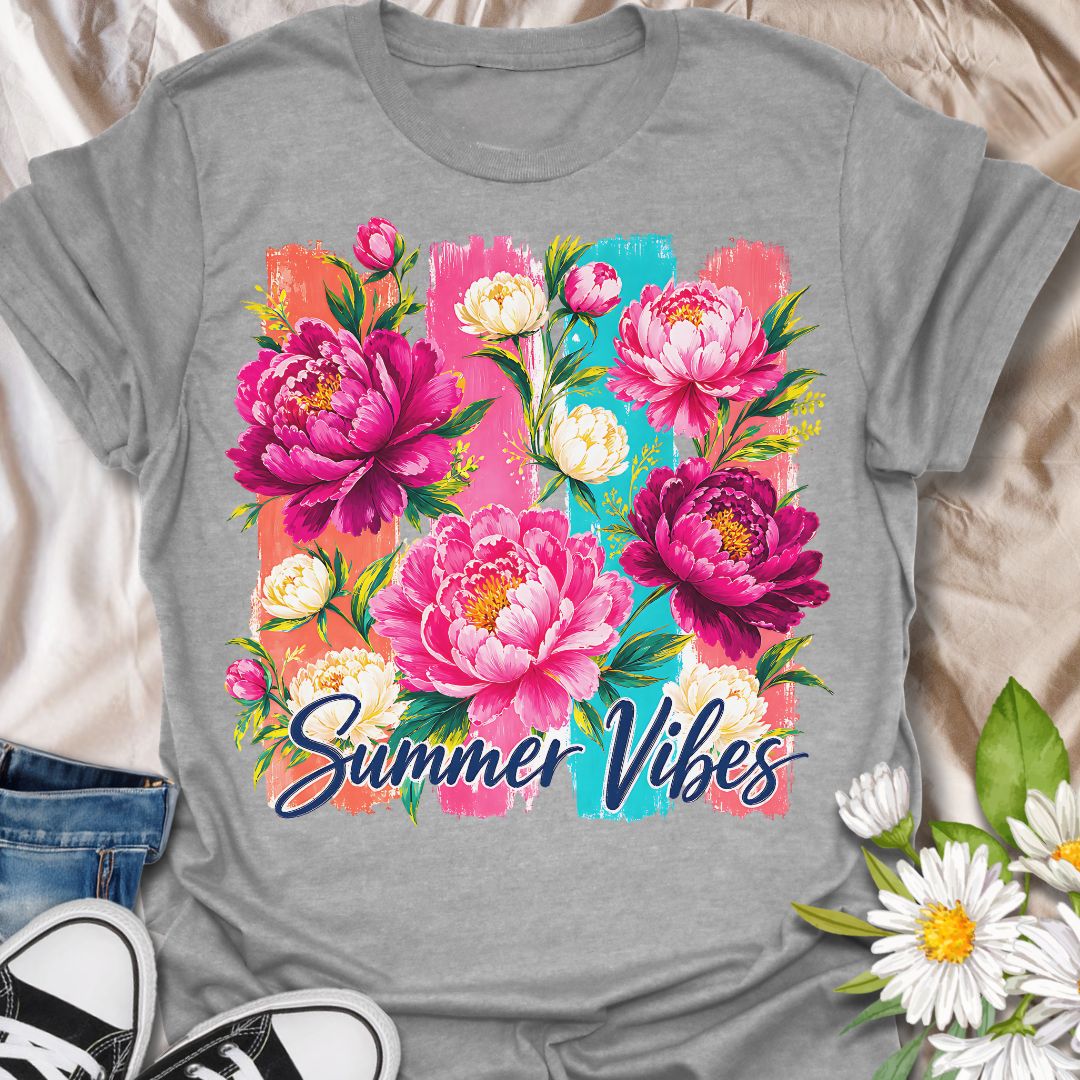 This Summer Vibes t-shirt is made for flower lovers who want a bright, cheerful design full of colour and warm-weather energy. Featuring bold pink peonies, soft cream blossoms, leafy greenery, painterly brushstroke panels, and flowing Summer Vibes lettering, this design has a fresh floral look that feels joyful and eye-catching. Perfect for garden lovers, flower fans, botanical style lovers, cottagecore outfits, summer wardrobes, and anyone who loves vibrant floral artwork.