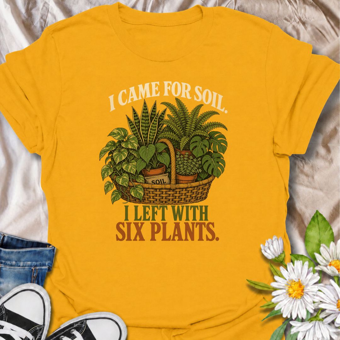 Funny houseplant T-shirt for plant lovers who visit the nursery for soil and leave with far more plants than planned. Featuring a vintage basket of lush houseplants and the line “I Came for Soil, I Left With Six Plants,” this is made for collectors who can never resist one more plant.