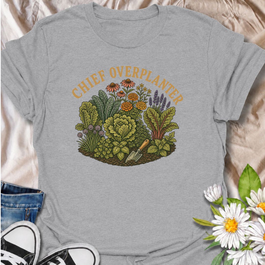 A funny gardening T-shirt for anyone who sees an empty patch of soil and immediately fills every inch of it. The “Chief Overplanter” phrase is perfect for enthusiastic gardeners who always squeeze in one more flower, herb, or vegetable. Featuring a lush garden bed packed with greenery and blooms, this design works especially well for cottage gardeners, backyard growers, and green-thumbed plant lovers. It makes a fun gift for gardeners who treat recommended spacing as more of a suggestion than a rule. Ideal 