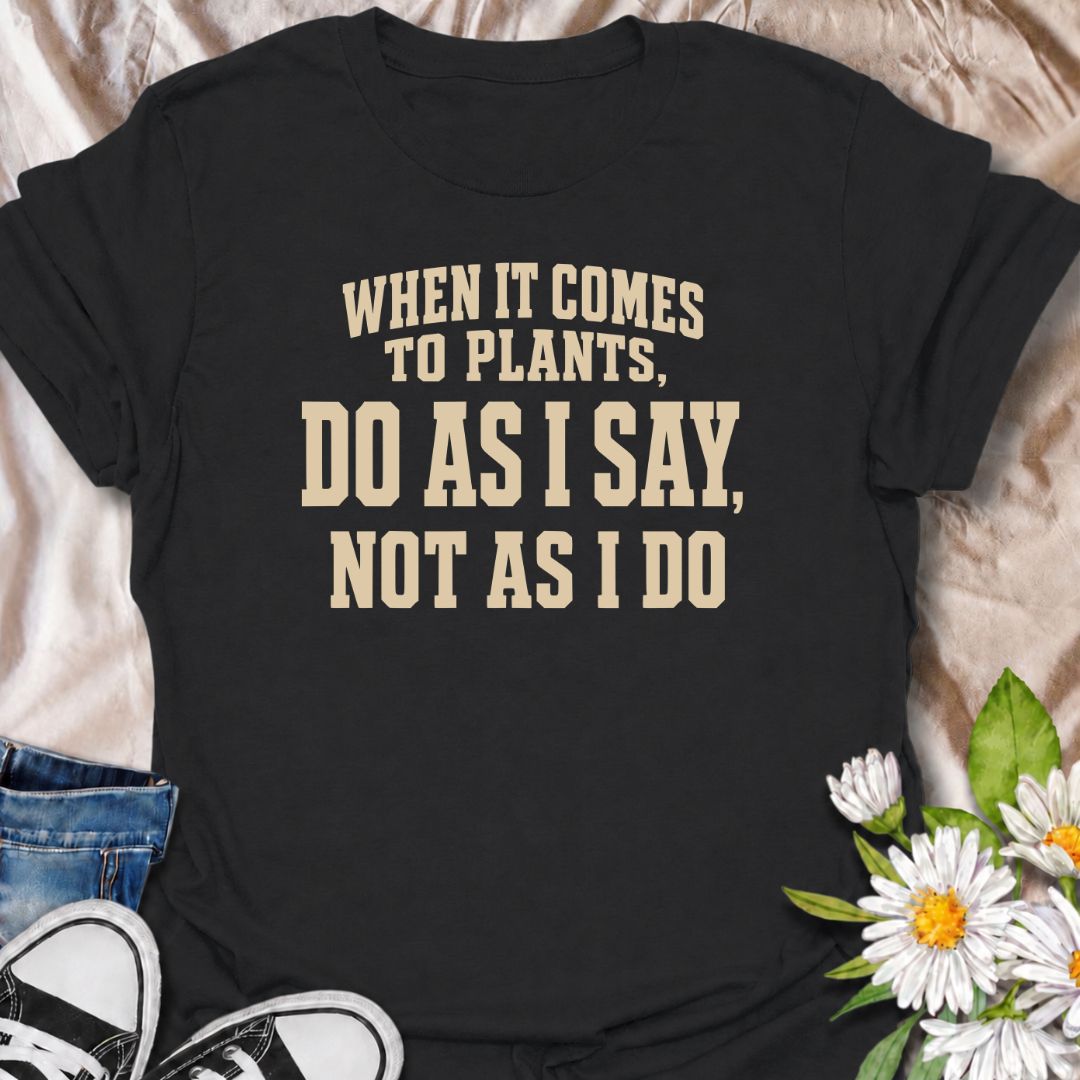 A funny plant T-shirt for anyone who gives excellent houseplant advice and then completely ignores it at home. The phrase “When It Comes to Plants, Do as I Say, Not as I Do” delivers dry, self-deprecating humor that experienced plant parents will recognize immediately. Perfect for houseplant collectors, indoor gardeners, and plant lovers whose own growing habits do not always match their expertise. The bold typography keeps the design clean, readable, and easy to wear. A great gift for plant enthusiasts, nu
