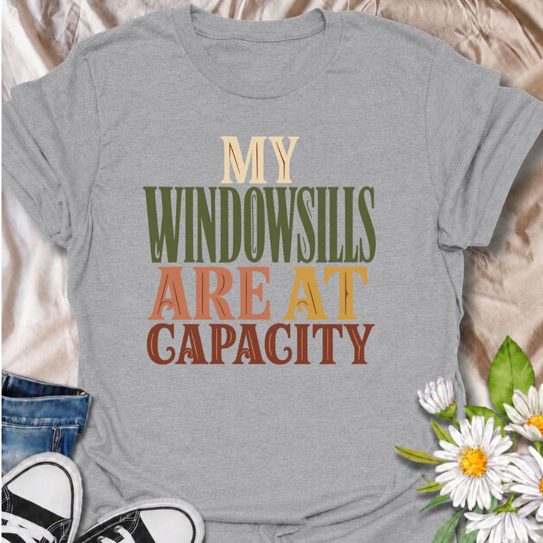 A funny plant T-shirt for anyone whose best windowsills are already completely claimed by houseplants. The phrase “My Windowsills Are at Capacity” is perfect for plant parents, indoor gardeners, and collectors who keep finding room for one more pot anyway. Its bold retro typography makes the design easy to read while keeping it simple and wearable. It makes a great gift for pothos lovers, houseplant collectors, and anyone with an ever-growing indoor jungle. Ideal for nursery trips, plant swaps, garden cente