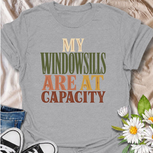A funny plant T-shirt for anyone whose best windowsills are already completely claimed by houseplants. The phrase “My Windowsills Are at Capacity” is perfect for plant parents, indoor gardeners, and collectors who keep finding room for one more pot anyway. Its bold retro typography makes the design easy to read while keeping it simple and wearable. It makes a great gift for pothos lovers, houseplant collectors, and anyone with an ever-growing indoor jungle. Ideal for nursery trips, plant swaps, garden cente