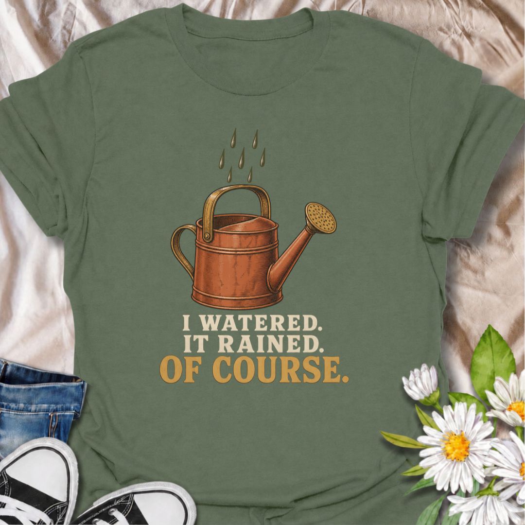 A funny gardening T-shirt for anyone who waters the garden just before the rain arrives. The phrase “I Watered. It Rained. Of Course.” captures one of those painfully familiar gardener moments with simple, dry humor. Featuring a vintage-style watering can and raindrops, this design is perfect for backyard gardeners, flower growers, and anyone who spends plenty of time checking the weather. It makes a great gift for gardeners who know nature rarely follows the plan. Ideal for garden days, nursery trips, farm