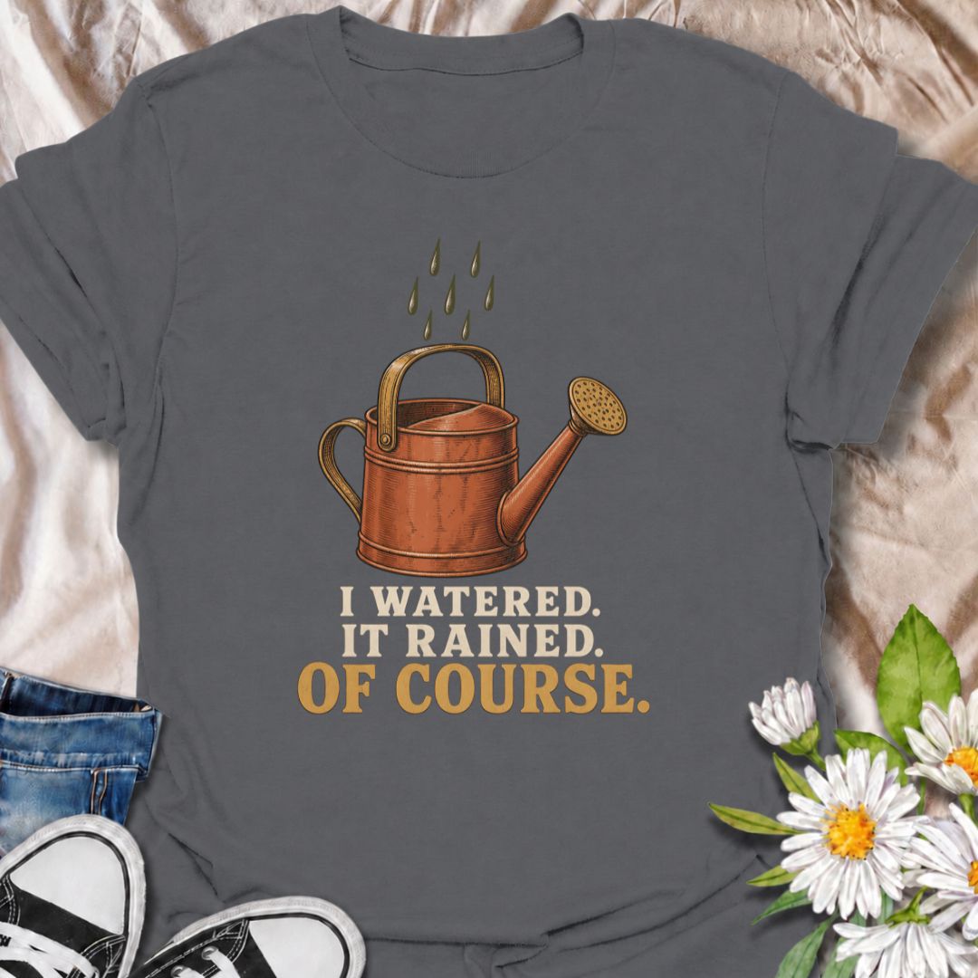 A funny gardening T-shirt for anyone who waters the garden just before the rain arrives. The phrase “I Watered. It Rained. Of Course.” captures one of those painfully familiar gardener moments with simple, dry humor. Featuring a vintage-style watering can and raindrops, this design is perfect for backyard gardeners, flower growers, and anyone who spends plenty of time checking the weather. It makes a great gift for gardeners who know nature rarely follows the plan. Ideal for garden days, nursery trips, farm