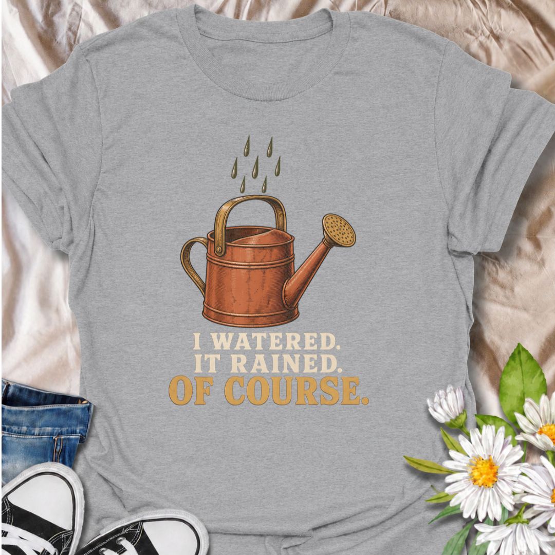 A funny gardening T-shirt for anyone who waters the garden just before the rain arrives. The phrase “I Watered. It Rained. Of Course.” captures one of those painfully familiar gardener moments with simple, dry humor. Featuring a vintage-style watering can and raindrops, this design is perfect for backyard gardeners, flower growers, and anyone who spends plenty of time checking the weather. It makes a great gift for gardeners who know nature rarely follows the plan. Ideal for garden days, nursery trips, farm