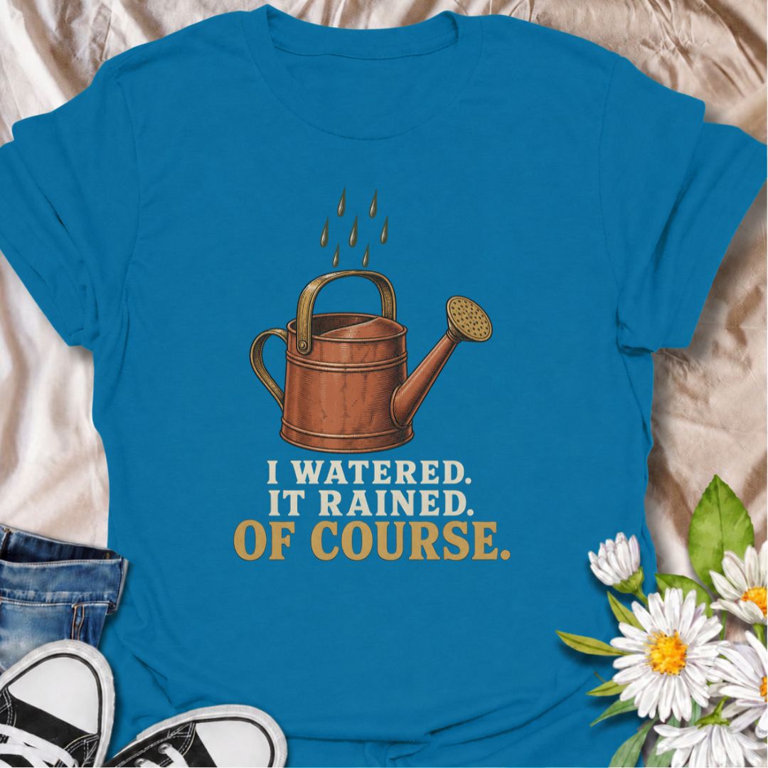 A funny gardening T-shirt for anyone who waters the garden just before the rain arrives. The phrase “I Watered. It Rained. Of Course.” captures one of those painfully familiar gardener moments with simple, dry humor. Featuring a vintage-style watering can and raindrops, this design is perfect for backyard gardeners, flower growers, and anyone who spends plenty of time checking the weather. It makes a great gift for gardeners who know nature rarely follows the plan. Ideal for garden days, nursery trips, farm