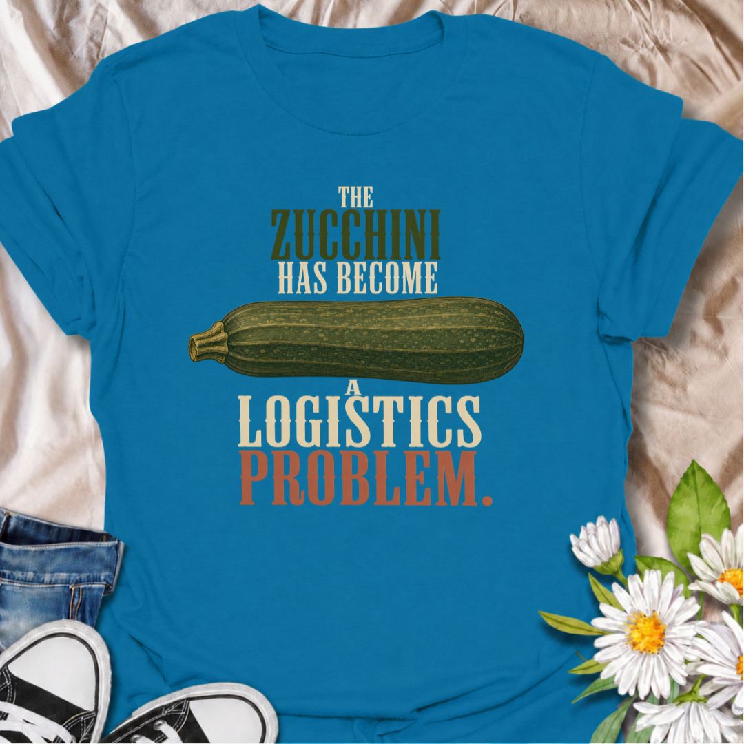 A funny gardening T-shirt for anyone who planted zucchini and then discovered just how productive one plant can be. The phrase “The Zucchini Has Become a Logistics Problem” perfectly captures that point in summer when the harvest starts taking over the kitchen. Featuring an oversized vintage-style zucchini, this design is ideal for vegetable gardeners, backyard growers, and anyone familiar with a bumper crop. It makes a great gift for gardeners who are forever giving away extra squash to friends and neighbo