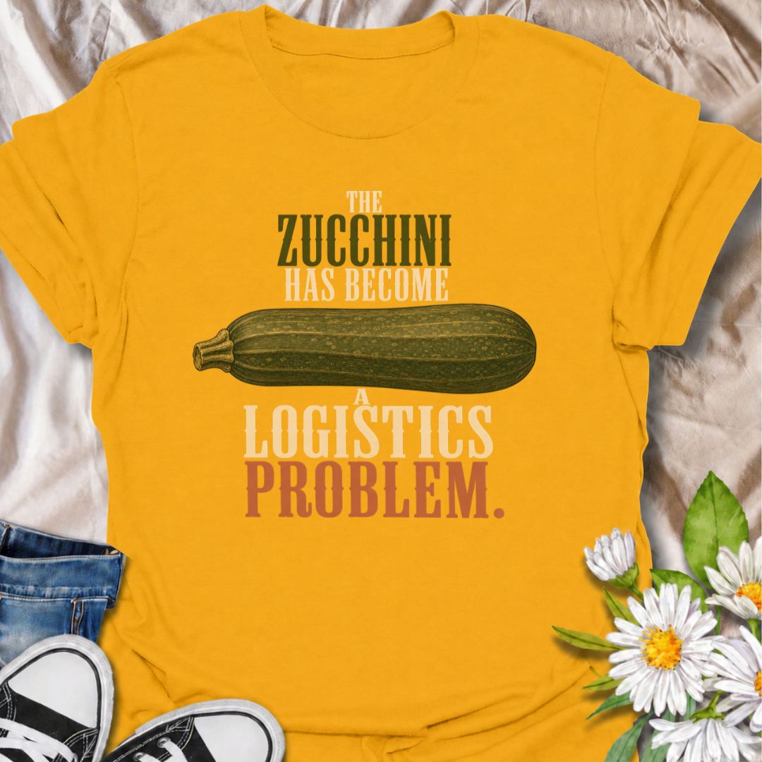 A funny gardening T-shirt for anyone who planted zucchini and then discovered just how productive one plant can be. The phrase “The Zucchini Has Become a Logistics Problem” perfectly captures that point in summer when the harvest starts taking over the kitchen. Featuring an oversized vintage-style zucchini, this design is ideal for vegetable gardeners, backyard growers, and anyone familiar with a bumper crop. It makes a great gift for gardeners who are forever giving away extra squash to friends and neighbo